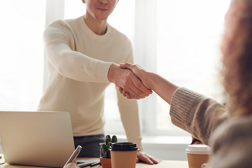 two employees shaking hands